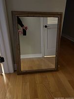 Front view of mirror showing rope-style frame and reflective surface