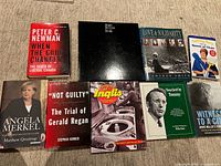 All nine books laid out on carpet showing covers