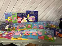 Front view showing assortment of Peppa Pig paperback and board books with visible titles
