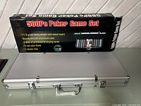 Closed aluminum poker case beside original 500-piece set box