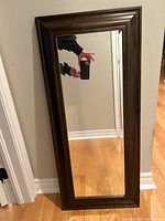 Front view of rectangular mirror with dark brown frame