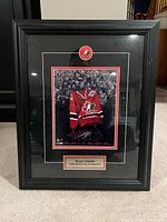 Front view of framed Team Canada 2004 World Cup Champions display showing photo, medallion, and nameplate