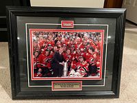 Front view showing photograph, frame, matting and plaque