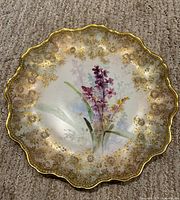 Full view of plate showing floral centre and gilt border