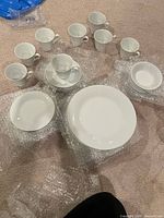 Overall set showing stacks of plates, bowls and cups