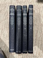 Spine view of four Collins hardcovers showing titles and volume numbers