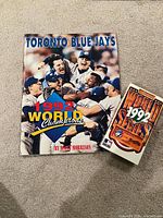 Book and VHS front covers displayed on carpeted floor