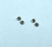 Four loose round diamonds on white background