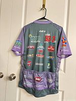 Rear view of jersey showing sponsor graphics and rear pockets
