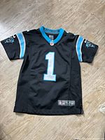 Front view of jersey showing number 1, sleeve logos, Nike label