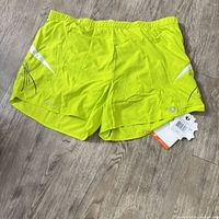 Front of shorts showing color, design, waistband, tags attached