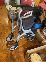 Side view of Evolution Xpresso Lite Regular C walker showing frame, wheels, seat and handlebars