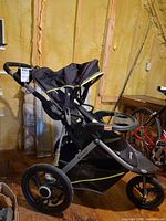 Side view of Baby Trend Velocity SX stroller showing three-wheel configuration and frame