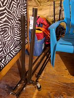 Full view of brown metal adjustable bed frame rails standing upright