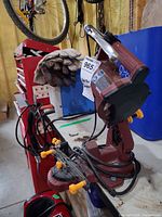 Front angled view of complete chainsaw sharpener on workbench