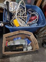 Blue tote and cardboard box filled with assorted electrical supplies