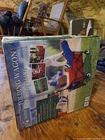 Factory sealed box showing Seina folding wagon graphics