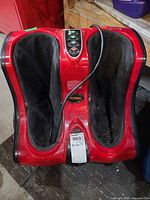 Front view of red and black HmRelax foot and calf massager with power cord visible