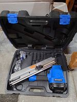 Open Mastercraft carry case showing framing nailer, magazine, and accessories