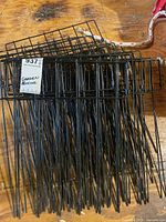 Stack of black metal garden fencing panels