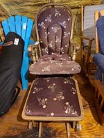 Front view of glider chair and ottoman showing upholstery pattern and wooden frame