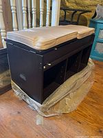 Overall view of wood bench with cushions and cubbies