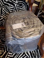 Factory-wrapped Rain Deway tarp rolled and secured in clear plastic