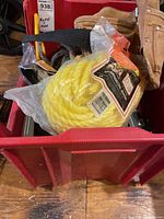 Overall contents in red bin: yellow rope, tool belt, spreader, paint brushes, brackets