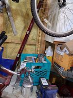 Lot overview showing spray gun, level, accessory items