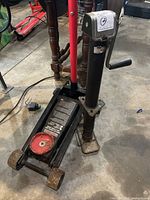 Overall view of Motomaster floor jack with handle attached