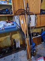 Group of paddles, nets, auger, rod holders