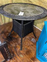 Full view of round glass top patio table