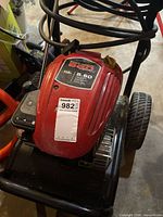Overall view of PowerBoss pressure washer showing engine, frame and hose