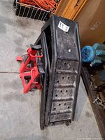 pair of car ramps stacked with two red jack stands