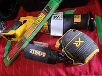 Reciprocating saw, palm sander and electrode pack grouped on surface, showing overall lot