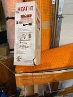 HeatIt electric kit box atop rolled Schluter Ditra-Heat membrane