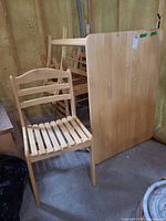 Table top and one chair visible, showing wood type and style