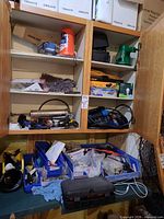 Cabinet shelves with Mastercraft nailer, grease gun, polisher, hardware bins