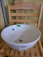 Top view of white ceramic vessel sink on chair