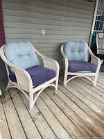 Both white wicker armchairs on deck
