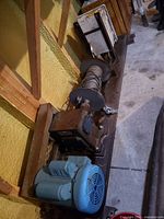 Full view of winch assembly on steel beam with motor, drum and gearbox