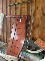 Wood and metal headboards leaning together with frame rails visible