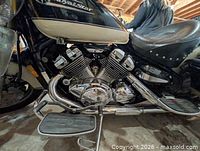 Left side view showing V4 engine, footboard, chrome exhaust, body panels