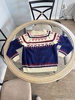 Front view of navy, cream and red Fair Isle wool sweater