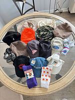 Full lot overview on round glass table showing all hats and socks