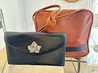 Bree tan leather crossbody bag and Brighton black wallet front view