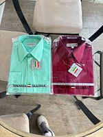 Both packaged shirts side by side showing colors and brand