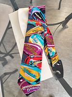 Full view of necktie showing overall print and colors