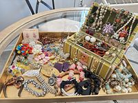 overview of full jewelry lot in tray with open jewelry box