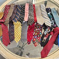 All ties spread on glass table showing patterns and colours